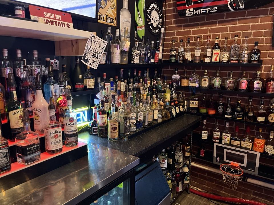 Back bar shelves full of liquor bottles